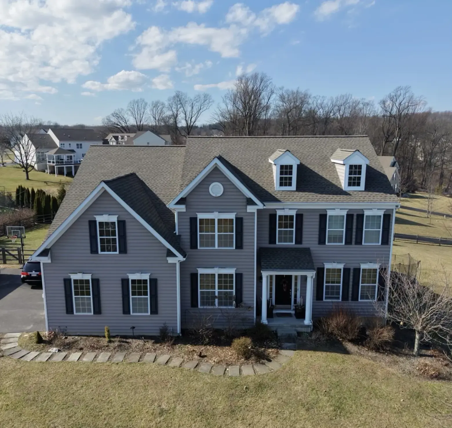 Newly replaced roof on a colonial home, front view